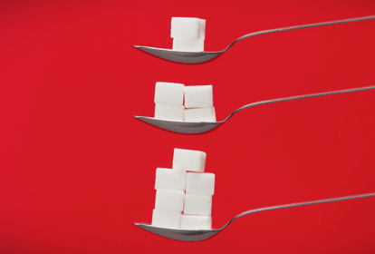 foto de cubos de açúcar em colheres demonstrando quantidade diária de consumo de açúcar